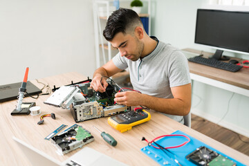 Engineer working on fixing a damaged computer