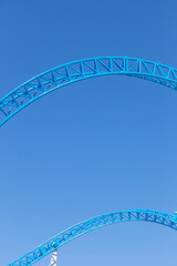 rollercoaster rails against blue sky