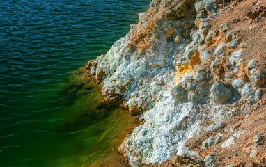 Mining tailings and toxic waste at a shore of an abandoned open pit copper mine. Crystals of iron...