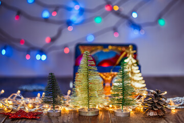 Christmas decorative trees on the background of multi-colored blinking garlands