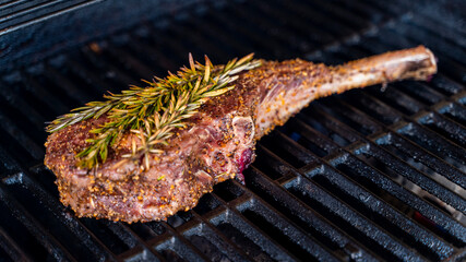 meat on the grill with rosemary