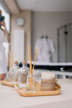 Lifestyle still life from the spa. Scented candle and fragrances. An atmosphere of relaxation and comfort. Hugge. Luxury beauty salon. Air freshener. Home perfume. Delicate tones. Calm and silence