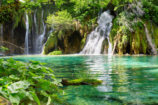 Waterfall in Plitvice Lakes national Park at summer, Croatia. Waterfalls formed by mountain lakes due to melting glaciers