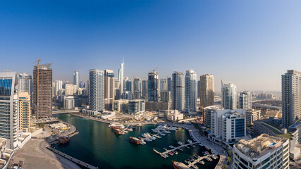 Fototapeta na wymiar DUBAI, UAE - DECEMBER 5, 2016: Aerial view of Marina buildings. Dubai attracts 15 million people annually