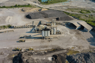 Arial view of the open pit mine gravel into stone crusher in heavy mining machinery equipment for...
