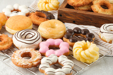 Many different donuts on a light background.