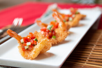 Panko-Crusted Shrimp Served on White Plate with Cubed Garnish.