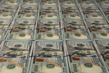 Some banknotes of hundred dollars in rows
