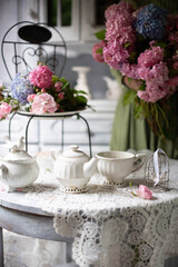 Still-Life with purple and pink Hortensia flowers, breakfast table setting.