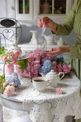 Still-Life with purple and pink Hortensia flowers, breakfast table setting.