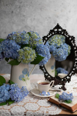 Amazing blue hydrangea flowers on the light table. Selective focus and close up image.