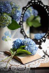Amazing blue hydrangea flowers on the light table. Selective focus and close up image.