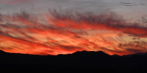 wispy cirrus clouds at  sunset over the colorado rockies, as seen from broomfield, colorado