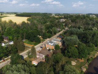 Aerial view of the Cheltenham area, a community within the town of Caledon, Ontario, Canada. Shot by a drone on a hazy summer afternoon along Creditview Road.