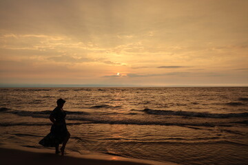 person on the beach at sunset