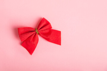 Red bow on a pink background.