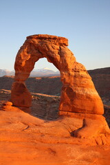 delicate arch and the la sal mountains in late afternoon, in arches national park, near moab,  utah