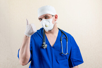 Doctor in mask and cap, showing thumbs up.