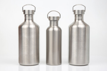 Steel flasks for water and drinks on a white background. Survival hiking gear