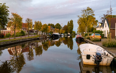 Geeuw canal with boats and houses, city of IJlst, Friesland, Netherlands