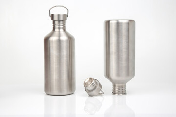 Steel flasks for water and drinks on a white background. Survival hiking gear