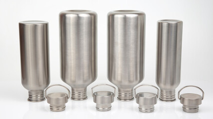 Steel flasks for water and drinks on a white background. Survival hiking gear