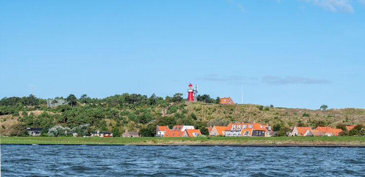 Vlieland with Vuurduin lighthouse on vuurboetsduin and East-Vlieland town from Waddensea, Friesland, Netherlands