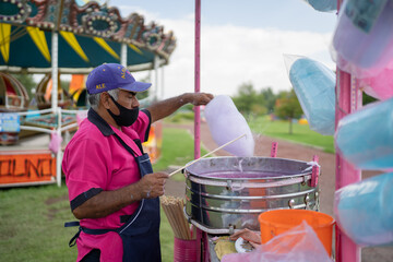 cotton candy vendor working at the fair