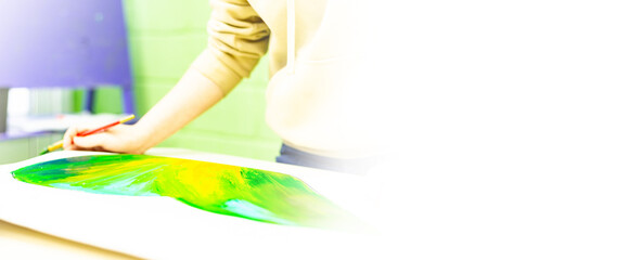 a person draws with a brush and paints on a large canvas in an art studio. creative, modern artist of fine art, a masterpiece of drawing, drawing training, art school, distance drawing courses, banner