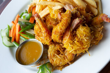 Coconut-Crusted Shrimp Served With Fries & Vegetables