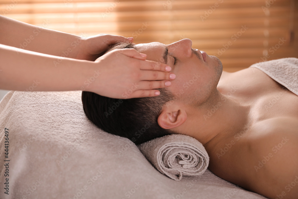 Wall mural Man receiving facial massage in beauty salon