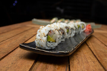 Salmon Roll Sushi on Black Plate