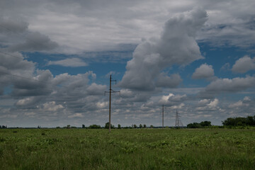 beautiful clouds in the field and power poles
