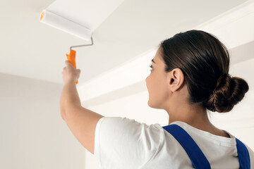 Worker painting ceiling with white dye indoors - obrazy, fototapety, plakaty