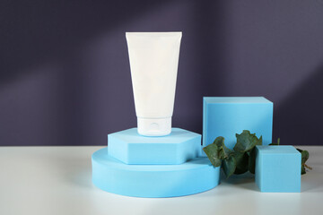 Cosmetic skincare container blank mockups in modern navy and blue styled setting with on trend shadow photography.