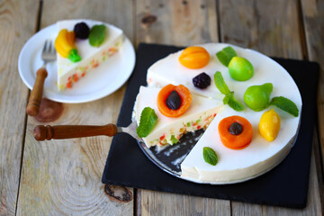 White soufflé cake with marmalade fruits.