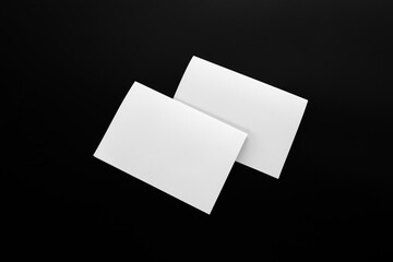 Blank Mock-up paper. brochure magazine isolated on black table, changeable background , white paper isolated on dark tone.