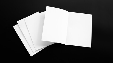Blank Mock-up paper. brochure magazine isolated on black table, changeable background , white paper...