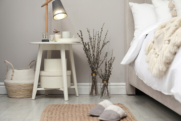 Bedroom interior with pussy willow branches and other decor