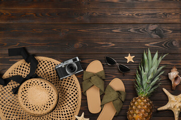 Flat lay composition with beach objects on wooden background, space for text
