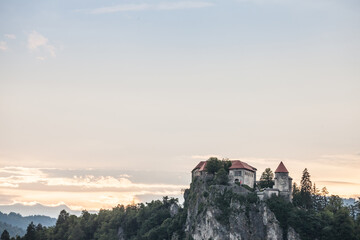 Selective blur on the Bled castle, also called Blejski Hrad, during summer, at sunset, by the mountains of Julian alps. Bled Castle is a major monument of Slovenia....