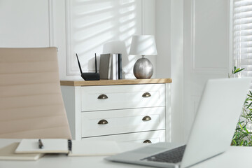 Modern wi-fi router on chest of drawers indoors