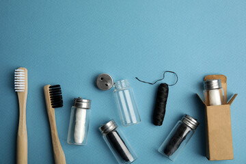 Flat lay composition with natural dental floss on light blue background. Space for text