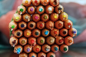 Bunch of colored crayons with water drops