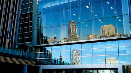 Fototapeta na wymiar Low Angle View Of Modern Buildings Against Blue Sky