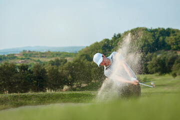 Golfers exploding sand in the bunker.. © nitinai2518