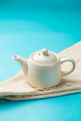 White ceramic teapot on a white cloth