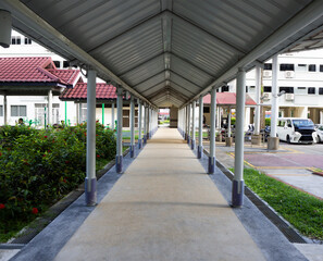 Sheltered walkway path in between blocks of flats in a housing estate in Singapore