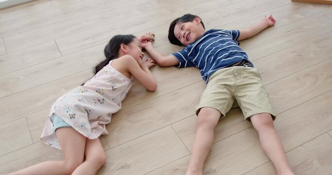 Happy sibling lying on floor,4K