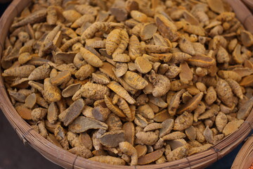 many dry Yellow roots row food in the market on the bamboo cage